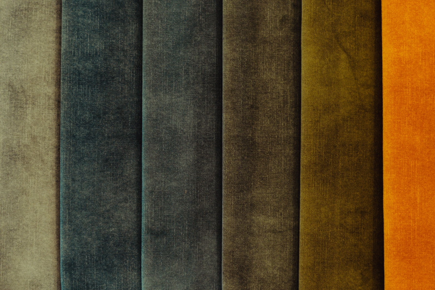 Fabric samples in grey, blue, olive and ochre, shown side by side during the Chateau d’Ax showroom visit